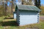 blue log outhouse buildings british columbia canada